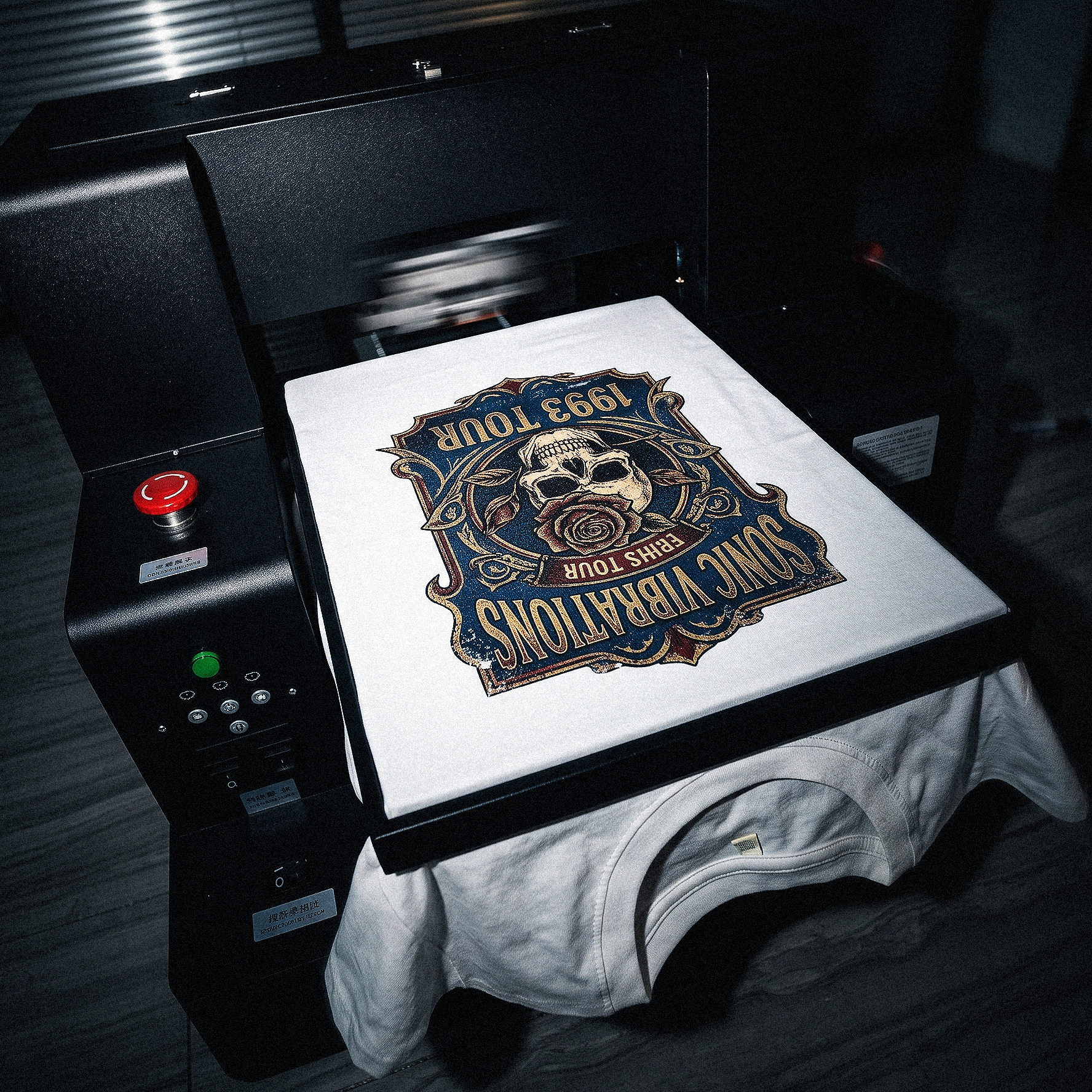 A DTG press printing full-colour tour artwork onto a white tee