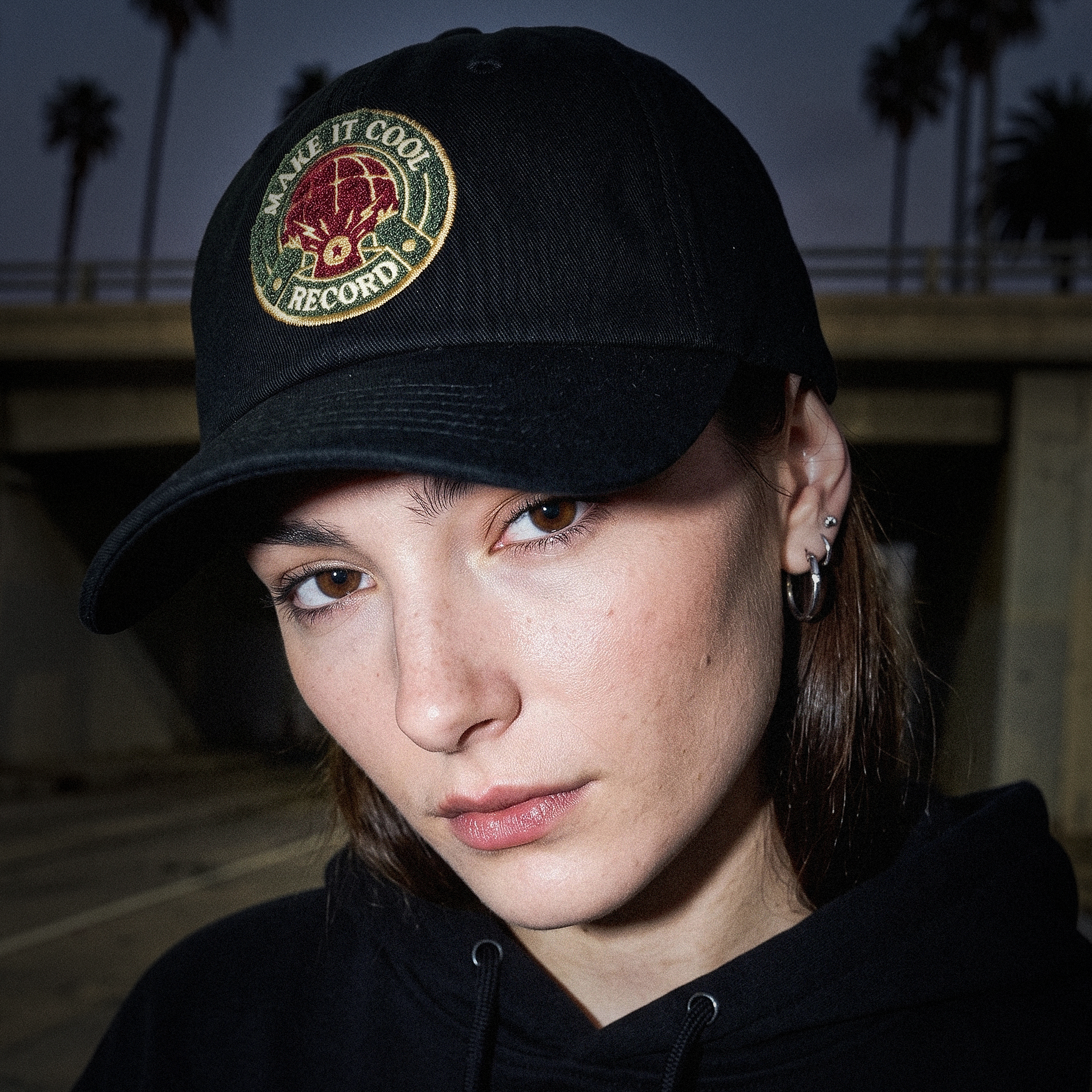 A black cap with an embroidered front-panel crest